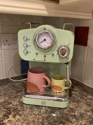 a coffee maker with two cups on a counter at Dog-friendly rural retreat in Bury Saint Edmunds