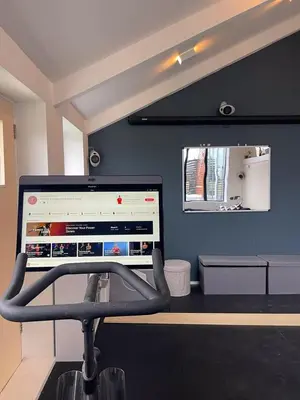 a room with a desk with a computer and a mirror at Luxurious Retreat with Cinema Lounge in Ely