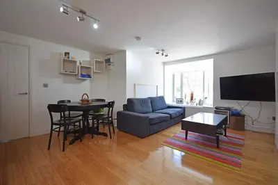 a living room with a couch and a table at Beautiful flat in a perfect location in Cambridge
