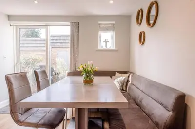 a living room with a table and a couch at North Cottage, Aldeburgh in Aldeburgh
