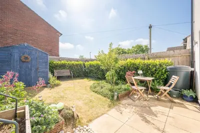 a garden with a table and chairs and a bench at Modern 2-Bed Home in Leiston in Leiston