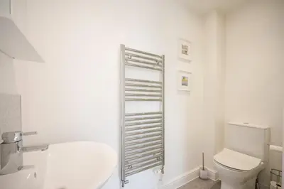 a white bathroom with a toilet and a sink at Modern 2-Bed Home in Leiston in Leiston