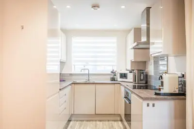 a white kitchen with a sink and a window at Modern 2-Bed Home in Leiston in Leiston