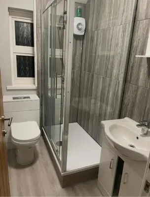 a bathroom with a shower and a toilet and a sink at Leiston house in Leiston