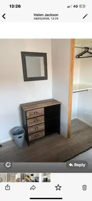 a room with a wooden dresser and a mirror at Leiston house in Leiston