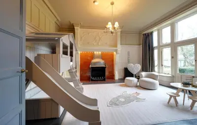 a living room with a staircase leading up to a kitchen at Herringswell Manor in Red Lodge