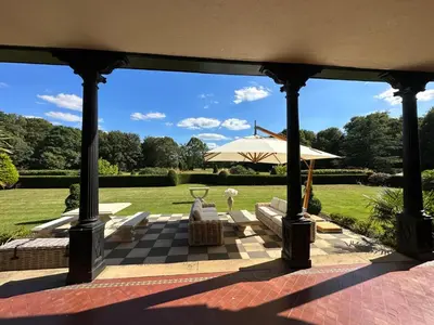 a gazebo with an umbrella and a chess board at Herringswell Manor in Red Lodge