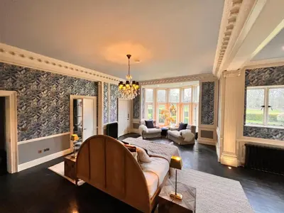 a living room with a bed and a couch in it at Herringswell Manor in Red Lodge