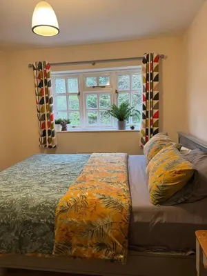 a bedroom with a bed and a window at Cosy Rural Retreat Perfect for Families and Pets in Tuddenham