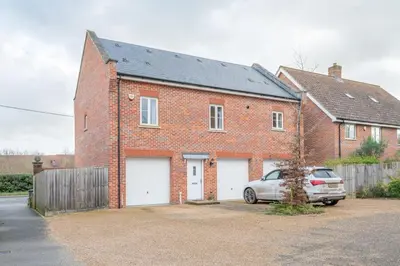a brick house with a car parked in front of it at Comfortable 2-Bedroom Home in Framlingham in Framlingham