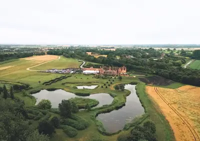 an aerial view of a castle and a river at The Old Hall Ely in Ely
