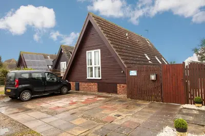 a black car parked in front of a house at Isleham River Lodge in Isleham