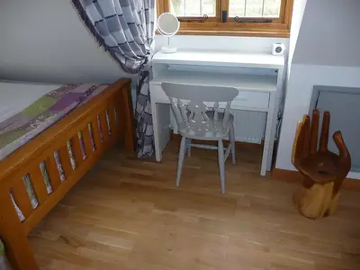 a bedroom with a desk and a chair next to a bed at Oakwrights in Terling