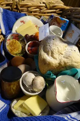 a basket filled with different types of cheese and other foods at Oakwrights in Terling