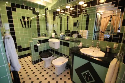a bathroom with two sinks and a toilet and a mirror at The PitStop in Bishops Stortford