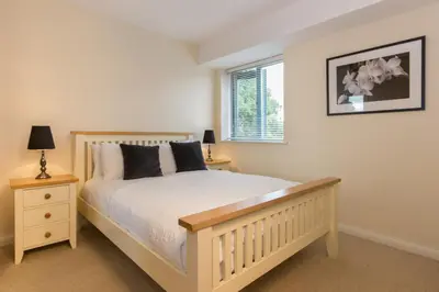 a bedroom with a white bed and a window at Citystay Living - Dove House in Cambridge