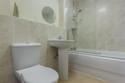 a bathroom with a toilet and a sink and a tub at Citystay Living - Dove House in Cambridge