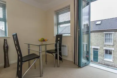 a dining room with a glass table and two chairs at Citystay Living - Dove House in Cambridge