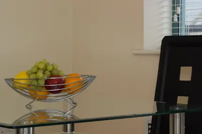 a bowl of fruit sitting on top of a glass table at Citystay Living - Dove House in Cambridge