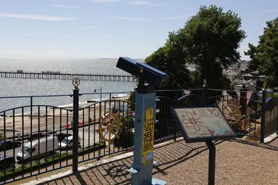 a sign on a pole next to a fence near the water at Hotel Coco in Felixstowe
