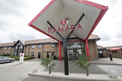 a restaurant sign in front of a building at Ramada Cambridge in Cambridge