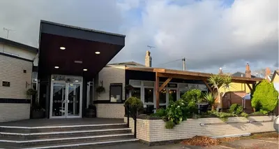 a house with a black roof and stairs at The Park Hotel - Sure Hotel Collection by Best Western in Diss