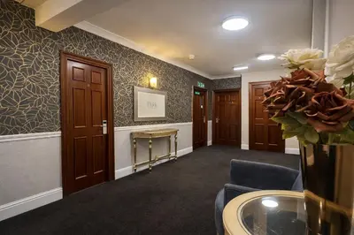 a waiting room with doors and a vase of flowers at The Park Hotel - Sure Hotel Collection by Best Western in Diss