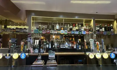 a bar filled with lots of bottles of alcohol at The Red Lion Hotel in Cambridge