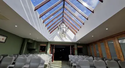 a room with chairs and a ceiling with a chandelier at The Red Lion Hotel in Cambridge