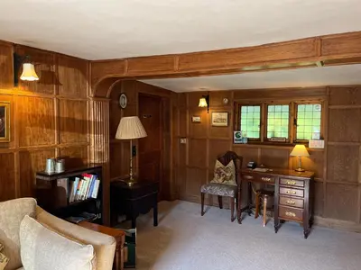 a living room with a desk and a chair at The Cottage Guest House in Bishops Stortford