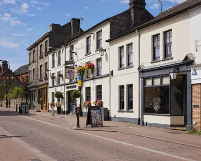 an empty street in a town with white buildings at The Bushel by Greene King Inns in Bury Saint Edmunds