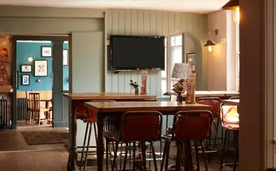 a dining room with a table and chairs at The Bushel by Greene King Inns in Bury Saint Edmunds
