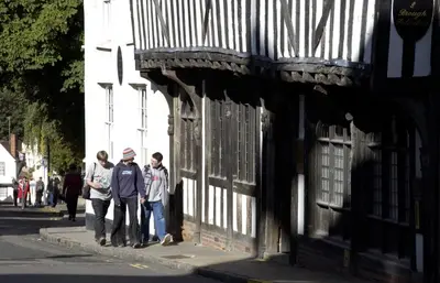 three people standing on a sidewalk next to a building at University of Essex - Colchester Campus in Colchester