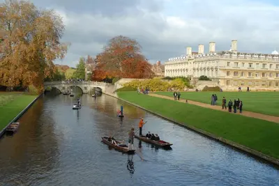 two boats in a river in front of a building at The Holly Tree in Cambridge