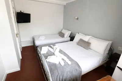 a bedroom with two beds with white towels on them at Aylesbray Lodge in Cambridge