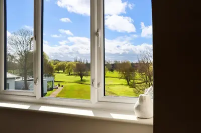 a window with a view of a green yard at All Saints Resort in Bury Saint Edmunds