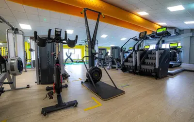 a gym with several treadmills and exercise bikes at All Saints Resort in Bury Saint Edmunds