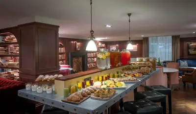 a buffet line with many different types of food at Clayton Hotel Cambridge in Cambridge