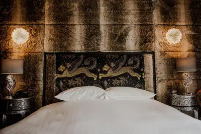 a bedroom with a bed and two lamps at The White Hart Hotel in Hingham