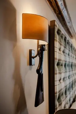 a lamp on a wall with a lamp on it at The White Hart Hotel in Hingham