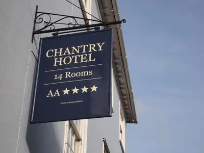a sign for a charity hotel on the side of a building at Chantry Hotel in Bury Saint Edmunds