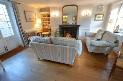 a living room with two couches and a fireplace at Chantry Hotel in Bury Saint Edmunds