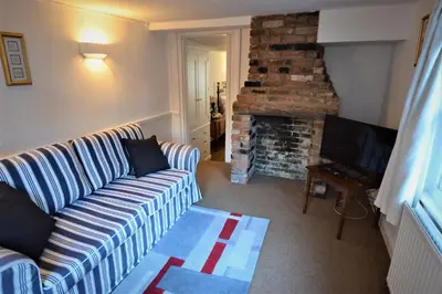 a living room with a couch and a fireplace at Chantry Hotel in Bury Saint Edmunds