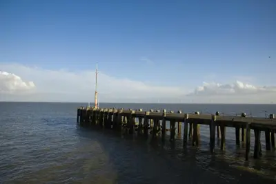 a pier in the water with people on it at Esplanade Hotel - Clacton On Sea, Beachfront Hotel by OYO in Clacton-on-Sea