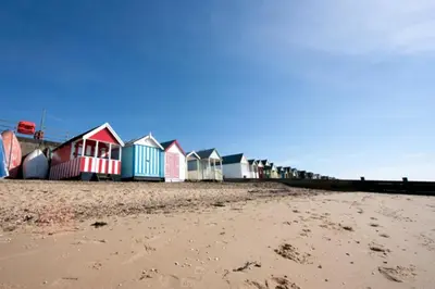 a row of colorful houses on the beach at Esplanade Hotel - Clacton On Sea, Beachfront Hotel by OYO in Clacton-on-Sea
