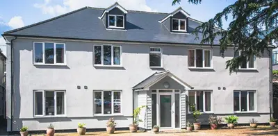 a white house with plants in front of it at County Hotel in Chelmsford