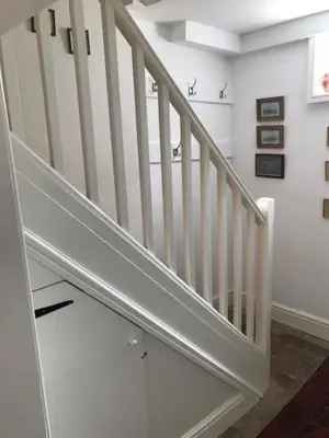 a white staircase in a room with white walls at Old Rectory - Scoulton in Great Ellingham