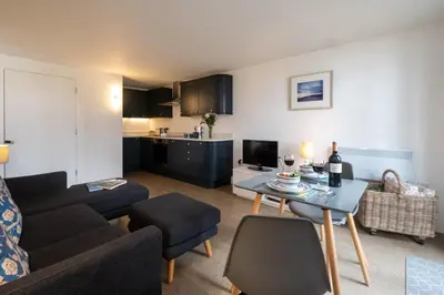 a living room with a couch and a table at Boat Lake in Thorpeness