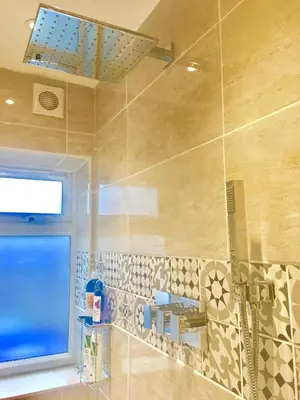 a bathroom with a shower and a window at Angel's (station accommodation) in Cambridge