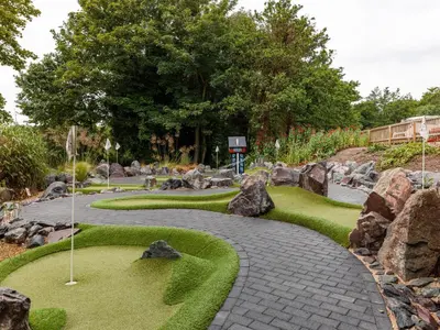 a stone path in a garden with rocks at Thorpeness Golf Club and Hotel in Thorpeness